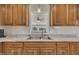 Bright kitchen featuring a double stainless steel sink and window that looks into the home's living space at 130 Hardy Rd, Wendell, NC 27591