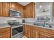 Modern kitchen featuring new stainless steel appliances, light countertops, and ample cabinet space at 130 Hardy Rd, Wendell, NC 27591