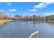 View from the edge of the private lake overlooking the shoreline and trees at 130 Hardy Rd, Wendell, NC 27591