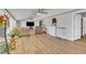 Bright living room featuring hardwood floors, ceiling fans, and access to the outdoors with a large window view at 130 Hardy Rd, Wendell, NC 27591