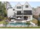 Stunning backyard oasis with a large pool, hot tub, outdoor seating, and a spacious two-story home at 1323 Ridge Rd, Raleigh, NC 27607