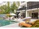 Backyard boasts a swimming pool, a jacuzzi, outdoor seating, lush greenery, and a multi-story house at 1323 Ridge Rd, Raleigh, NC 27607