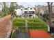 Backyard featuring a pool, sport court, trampoline, multi-level grass, and outdoor seating areas at 1323 Ridge Rd, Raleigh, NC 27607