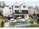 Luxurious backyard featuring a pristine pool, comfortable seating areas, and a beautifully designed modern exterior at 1323 Ridge Rd, Raleigh, NC 27607