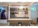 Basement bar with custom lighting, built-in shelves, and a sleek countertop at 1323 Ridge Rd, Raleigh, NC 27607
