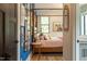 Stylish bedroom featuring a four-poster bed, art-filled walls, and hardwood floors at 1323 Ridge Rd, Raleigh, NC 27607