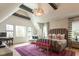 Spacious bedroom with a king bed, accent seating, and lots of natural light from large windows at 1323 Ridge Rd, Raleigh, NC 27607