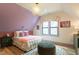 Cozy bedroom with an accent wall, decorative lighting, and hardwood floors at 1323 Ridge Rd, Raleigh, NC 27607
