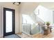 Bright foyer showcases a modern staircase, stylish lighting, and a chic seating area at 1323 Ridge Rd, Raleigh, NC 27607