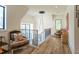 Upstairs hallway with seating area, natural light, and modern light fixtures at 1323 Ridge Rd, Raleigh, NC 27607