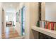 Bright hallway with wood floors and accent furniture that leads to the bedrooms at 1323 Ridge Rd, Raleigh, NC 27607