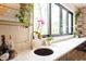 Bright kitchen featuring white countertops, a gold faucet, modern finishes, and sleek black cabinets at 1323 Ridge Rd, Raleigh, NC 27607