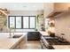 Bright kitchen with modern appliances, white countertops, black cabinets, and a stylish gold faucet at 1323 Ridge Rd, Raleigh, NC 27607