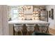 Modern kitchen featuring a large island, stylish bar stools, and a stone accent wall at 1323 Ridge Rd, Raleigh, NC 27607