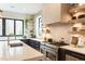 Bright kitchen with modern appliances, white countertops, black cabinets, and a stylish gold faucet at 1323 Ridge Rd, Raleigh, NC 27607