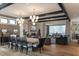 Open-concept space with modern lighting, a dining area, and a cozy living space with fireplace at 1323 Ridge Rd, Raleigh, NC 27607