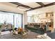 Spacious living room with patio access, a comfortable sofa, and a peek into the modern kitchen at 1323 Ridge Rd, Raleigh, NC 27607