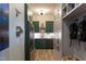 Mudroom features gray and dark green cabinets, stainless steel appliances, light hardwood floors, and built in storage at 1323 Ridge Rd, Raleigh, NC 27607