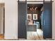 Open office features stylish sliding doors, a modern chandelier, and an executive desk with leather chair at 1323 Ridge Rd, Raleigh, NC 27607