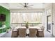 Relaxing screened porch features an outdoor dining area with wicker chairs and views of the wooded backyard at 1323 Ridge Rd, Raleigh, NC 27607