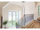 Bright staircase with modern railing, lots of natural light, and wood-look floors at 1323 Ridge Rd, Raleigh, NC 27607