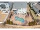 Aerial view of a private backyard oasis featuring a custom pool, spa, and ample patio space for entertaining at 1327 Gloriosa St, Apex, NC 27523