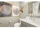 Stylish half bathroom with modern fixtures, decorative art, and a clean aesthetic at 1327 Gloriosa St, Apex, NC 27523