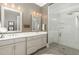 Elegant bathroom showcasing double vanity sinks and a frameless glass shower at 1327 Gloriosa St, Apex, NC 27523