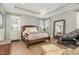 Cozy bedroom featuring tray ceilings, hardwood floors, and ample natural light at 1327 Gloriosa St, Apex, NC 27523