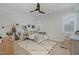 Bright bedroom with neutral decor, ceiling fan, and window at 1327 Gloriosa St, Apex, NC 27523