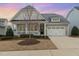 Charming home with a well-manicured lawn, inviting front porch, and a convenient two-car garage at 1327 Gloriosa St, Apex, NC 27523