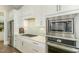 Modern kitchen featuring stainless steel appliances, white cabinetry, and a sleek backsplash at 1327 Gloriosa St, Apex, NC 27523