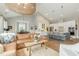 Open-concept living room with modern lighting, hardwood floors, and a seamless flow into the kitchen at 1327 Gloriosa St, Apex, NC 27523