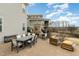 Outdoor living area with fireplace, dining, and ample seating at 1327 Gloriosa St, Apex, NC 27523