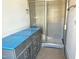 Bathroom featuring a gray vanity and a large walk-in shower with tile surround at 1448B Maplewood Dr, Durham, NC 27704