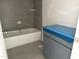 Bathroom featuring a white tub, gray tile surround, and gray vanity at 1448B Maplewood Dr, Durham, NC 27704