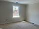 A bright bedroom featuring a window allowing natural light at 1448B Maplewood Dr, Durham, NC 27704