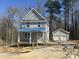 A new construction home boasts a charming two-story facade and detached garage at 1448B Maplewood Dr, Durham, NC 27704