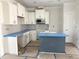 Modern kitchen with white cabinetry, stainless steel appliances, and an island at 1448B Maplewood Dr, Durham, NC 27704