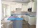 Kitchen with white cabinetry, stainless steel microwave, and a center island at 1448B Maplewood Dr, Durham, NC 27704