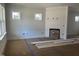 Bright living room with white walls, windows, and a fireplace, under construction at 1448B Maplewood Dr, Durham, NC 27704
