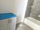 Bathroom featuring a new gray vanity and combination shower-tub with gray tiling at 1448C Maplewood Dr, Durham, NC 27704