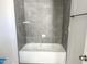 New bathroom features tub with gray tiling at 1448C Maplewood Dr, Durham, NC 27704