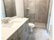 En suite bathroom includes double vanity, quartz counters, and glass shower at 1448C Maplewood Dr, Durham, NC 27704