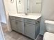 This en suite features a vanity with gray cabinet and quartz countertop at 1448C Maplewood Dr, Durham, NC 27704