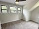 Bedroom featuring neutral carpet, light walls, and bright windows with outdoor views at 1448C Maplewood Dr, Durham, NC 27704