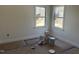 Bright bedroom with two windows showing the exterior and white walls, freshly painted at 1448C Maplewood Dr, Durham, NC 27704