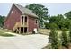 Exterior back of home with a concrete driveway, stairs to the porch, and a newly constructed fence at 1448C Maplewood Dr, Durham, NC 27704