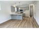Stylish kitchen features gray cabinets, stainless appliances, and breakfast bar at 1448C Maplewood Dr, Durham, NC 27704