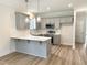 This open kitchen features gray cabinets, white countertops, and stainless appliances at 1448C Maplewood Dr, Durham, NC 27704
